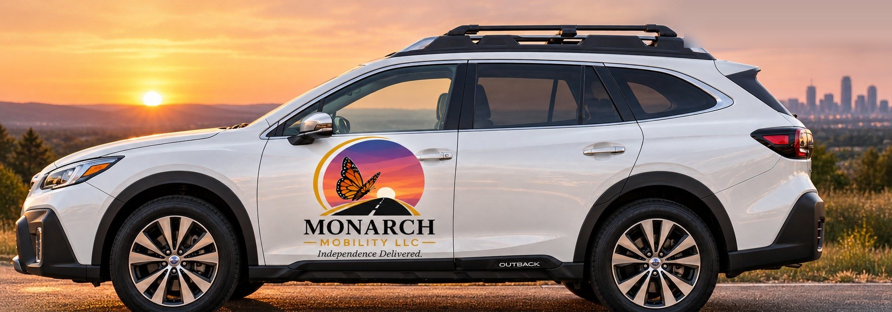 The Monarch Mobility Subaru Outback at sunset, with the butterfly-and-sunset logo on the front door.